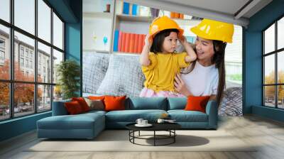 An Asian mother and daughter play as an engineer in command Wall mural