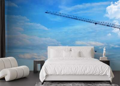 Apartment building construction concept and residential renovation. Copy panoramic area. Construction crane working on building site against blue background . Wall mural