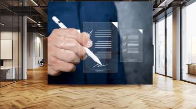 Electronic signature and paperless office concept. A businessman uses a pen to sign electronic documents on digital documents on a virtual screen. Wall mural