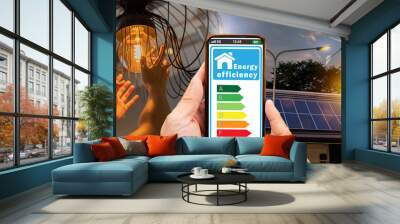 Solar panels and wind generator against city view at sunset. Home appliance energy efficient. Household equipment and energy class chart. Wall mural