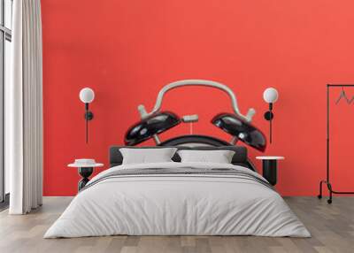 Black alarm clock on red background Wall mural