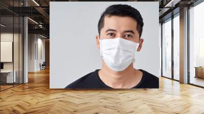 Young man in protective medical mask. Wall mural