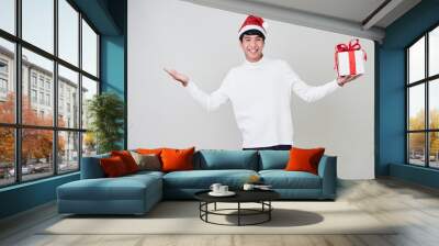 Young man with christmas gift box Wall mural