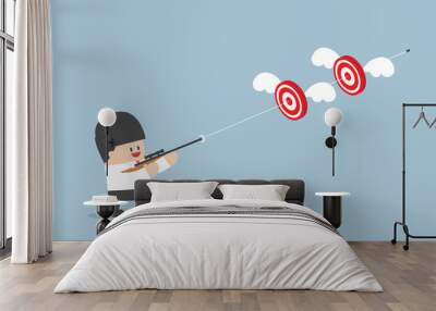 Businessman shoot two targets with one bullet Wall mural