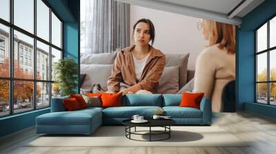 A young woman in a consultation with a professional psychologist listens to advice on improving behavior in life. The modern millennial woman is developing mindfulness and psychological health Wall mural