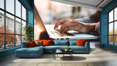 Close up of a business man working on a laptop, typing with his hands for work in office environment home office Wall mural