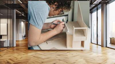 A woman architecture student working on models Wall mural