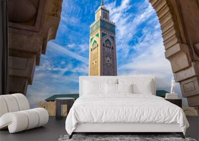 View of Hassan II mosque tower against blue sky - The Hassan II Mosque or Grande Mosquée Hassan II is a mosque in Casablanca, Morocco. Wall mural