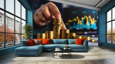 A business professional stacking gold coins as a symbol of investment growth and financial success in a modern setting. Wall mural