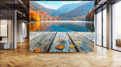 A serene autumn landscape featuring colorful foliage reflected in a calm lake, with a wooden dock adorned by fallen leaves. Wall mural