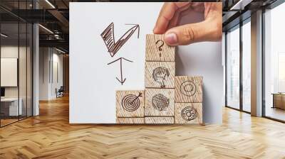 A sketch illustration of a hand placing a wooden block labeled 4 on top of a stack of blocks arranged in ascending order The blocks feature handdrawn arrows and targets Wall mural