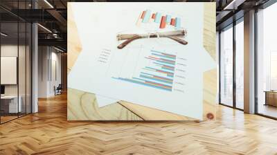 business concept : graph with glasses on stock market report as Wall mural