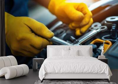 Close-up of hands in yellow gloves using a wrench to repair an engine. Wall mural