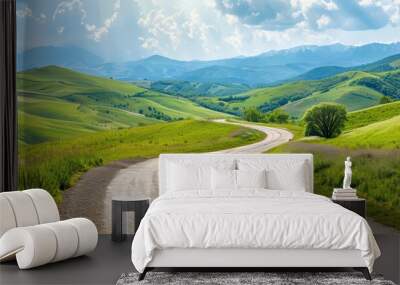 Serene winding road through lush green hills under a bright sky, perfect for nature lovers and travel enthusiasts. Wall mural