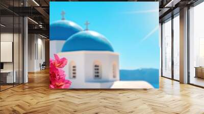 Vibrant bougainvillea flowers beside traditional Greek architecture under a bright sunny sky. Wall mural