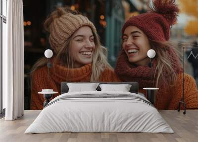 Two women enjoying coffee together in a cozy café, smiling and sharing a joyful moment over their drinks Wall mural