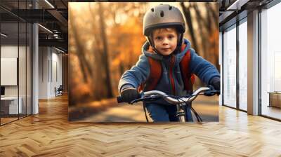 A child boy in bicycle helmet riding a bicycle for the first time. Wall mural