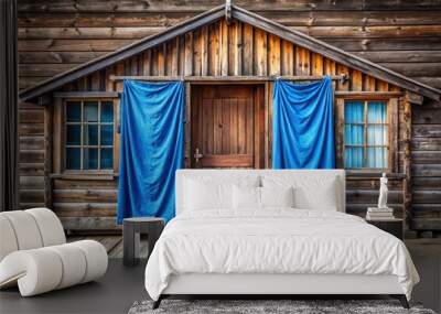 Rustic wooden house with blue curtain entrance Wall mural