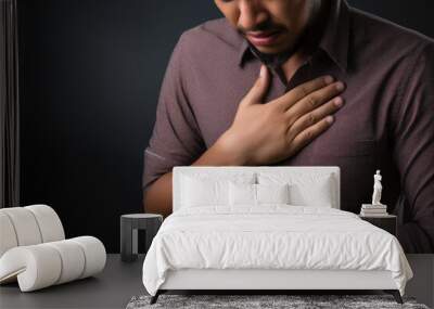 young man pressing chest painful Wall mural