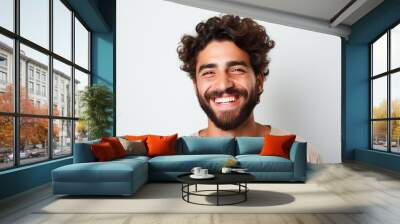 advertising portrait of smiling attractive young man with white teeth. Friendly expression. Spanish features. About 25 years old. Blurred background. Wall mural