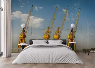 Four large yellow cranes in the port of Huelva, Spain Wall mural