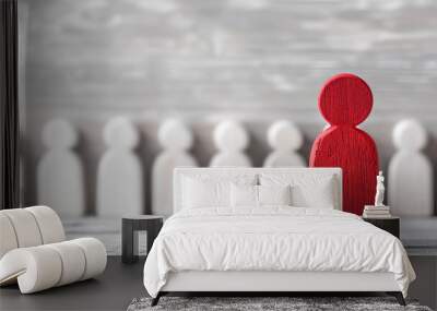 Red wooden figure leading a group of white figures Wall mural