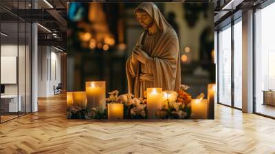 A statue of Jesus is surrounded by candles, creating a serene Wall mural