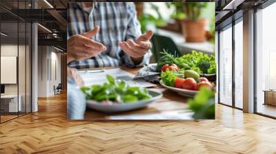 Elderly person consulting a healthy food diet with their nutritionist. Table with salad, vegetables and prescription papers or elderly care diet. Wall mural