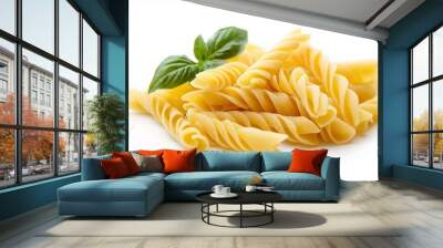 Pile of dry rotini pasta and basil leaf isolated on white background.	 Wall mural