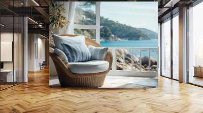 Straw armchair near window with view on sea bay. Wall mural