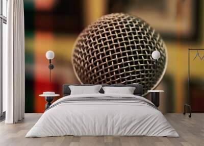 Close up on a metal microphone, with a blurry background Wall mural