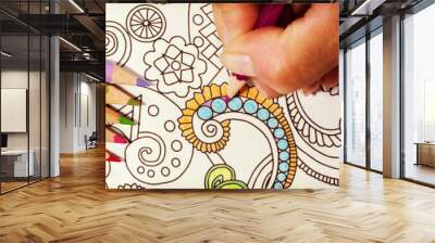 An image of a new trendy thing called adults coloring book.  In this image a person is coloring an illustrative and detailed pattern for stress relieve . Image has a vintage effect applied. Wall mural