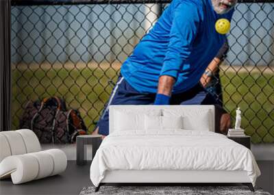 Adult male pickleball with eyes on the ball Wall mural