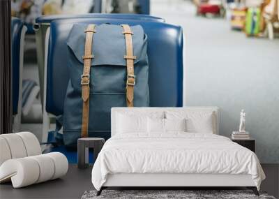 Blue vintage bag on seat at the interior of airport terminal. Travel and back to school concept Wall mural