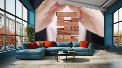 Businesswoman hand cover wooden block on the tower. Business planning, Risk Management, Solution, insurance and strategy Concepts Wall mural