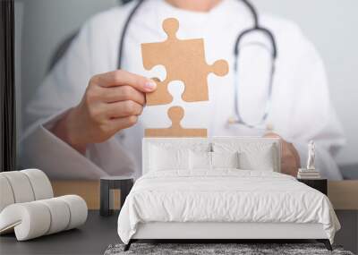 Doctor hand connecting couple puzzle piece, wooden jigsaw in hospital. Teamwork, Idea, Solution, challenge, success, Health, Medical and strategy concepts Wall mural