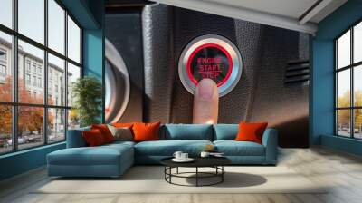 Finger press a car ignition button or START engine inside modern electric automobile. Keyless, change, strategy, vision, innovation and future concept Wall mural