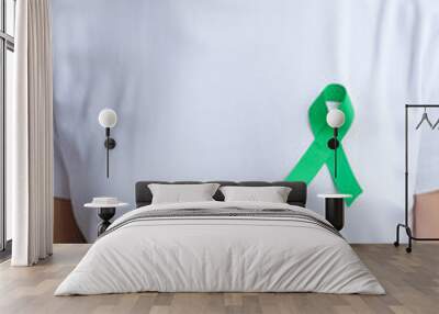 green Ribbon for Liver, Gallbladders, bile duct, cervical, kidney Cancer and Lymphoma Awareness month. Healthcare and world cancer day concept Wall mural