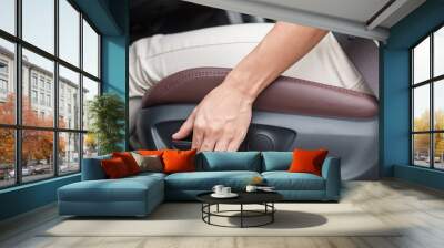 Hand adjust car seat before drive on the road . Ergonomic and safety transportation concept Wall mural