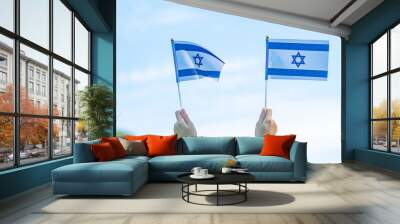 hand holding Israel flag on nature background. Israel Independence day and happy celebration concepts Wall mural