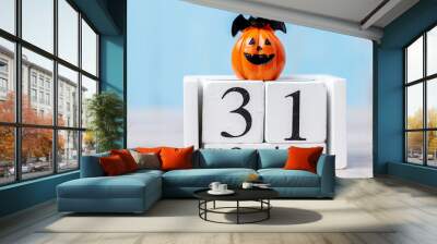 Happy Halloween day with 31 October calendar wood, jack o lantern pumpkin and bat decor with funny face on table background with copy space. Autumn season, Holiday and Trick and Treat concept Wall mural