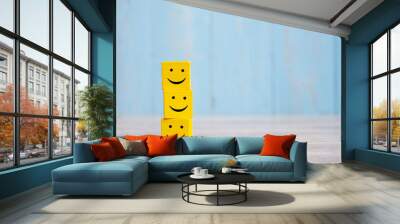 smile face on yellow wood cube. Service rating, ranking, customer review, satisfaction and emotion concept. Wall mural