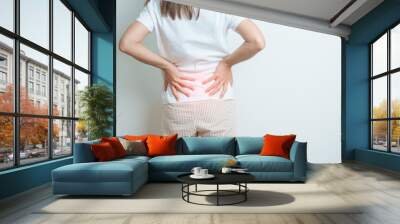 woman having back body ache during at home. adult female with muscle pain due to Piriformis Syndrome, Low Back Pain and Spinal Compression. Office syndrome and medical concept Wall mural