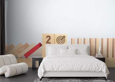 wood block falling to 2025 year and business icon with brainstorming, Target, goal, teamwork and strategy. risk management, Insurance and economic recession Wall mural