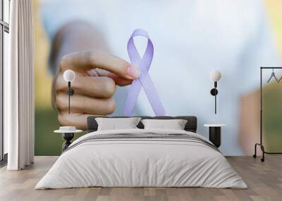 World cancer day (February 4). Woman hand holding Lavender purple ribbon for supporting people living and illness. Healthcare and medical concept Wall mural