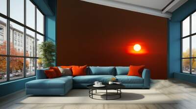 A red sun is in the sky with a dark background Wall mural