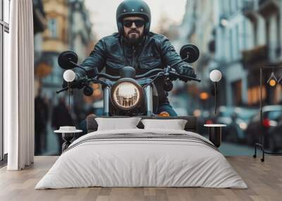 A biker in a black leather jacket and helmet rides a classic motorcycle through a busy city street, embodying freedom and adventure amid urban life. Wall mural