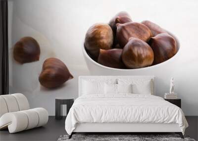 Bowl of chestnuts on a white background Wall mural