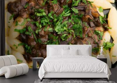 Freshly cooked, Polish traditional potato dumplings serving with mushroom sauce and fresh parsley Wall mural