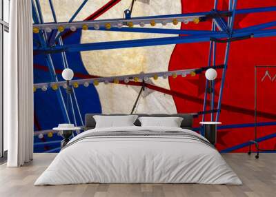 red white and blue abstract image of the tent roof and lights of an amusement park ride on the midwa Wall mural